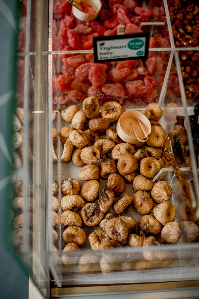 gallery-4 Detailed view of dried figs and fruits in a market display, showcasing freshness and variety.